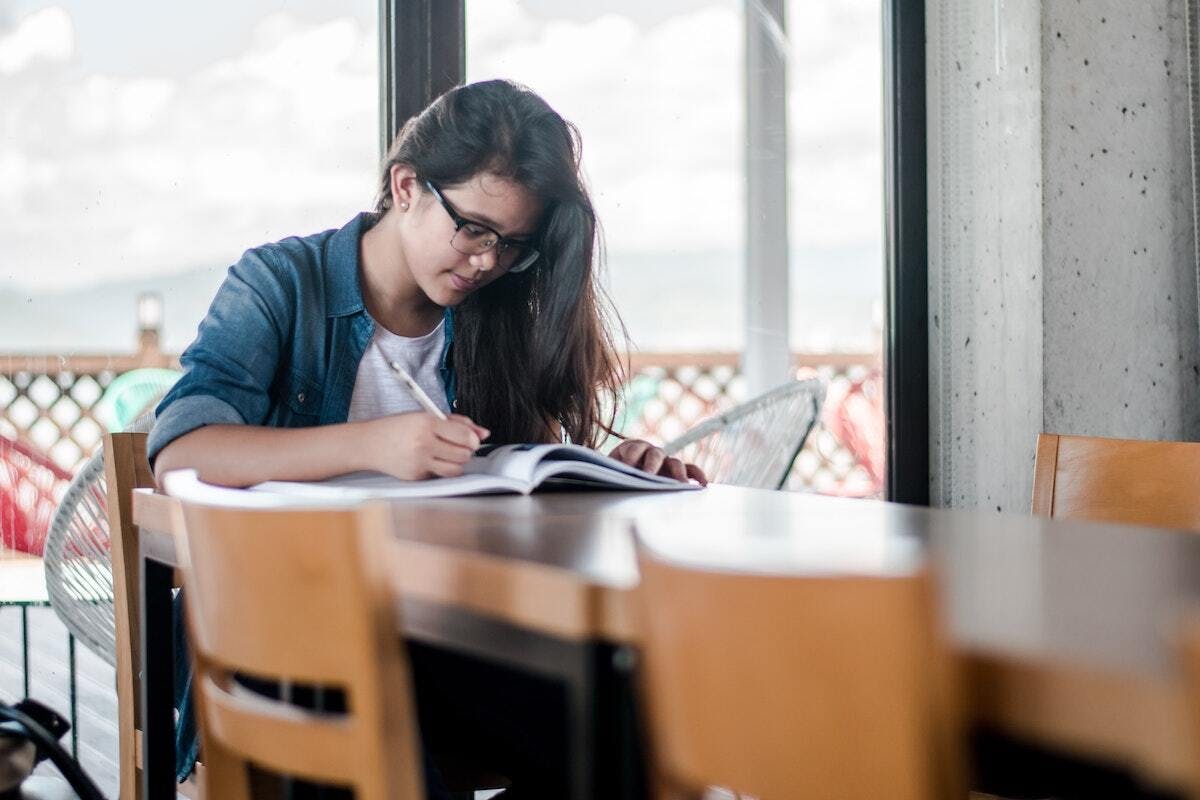 A BGCSC member studies from an ACT prep for students book.